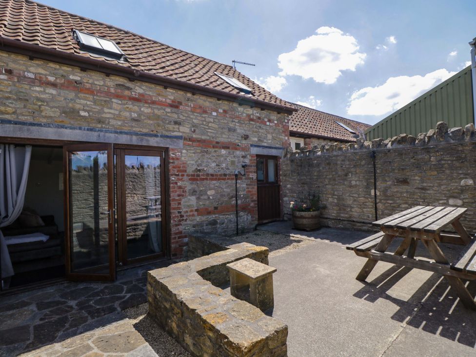An outdoor area with a seating table at Barn Cottage in Frome