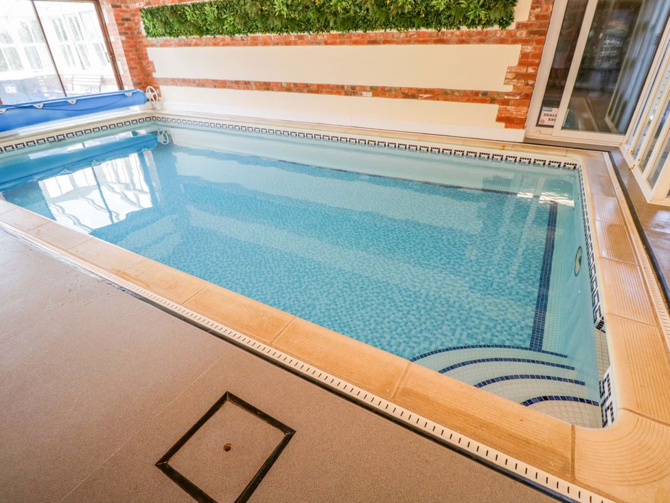 An indoor pool with clear water at Barn Cottage in Frome