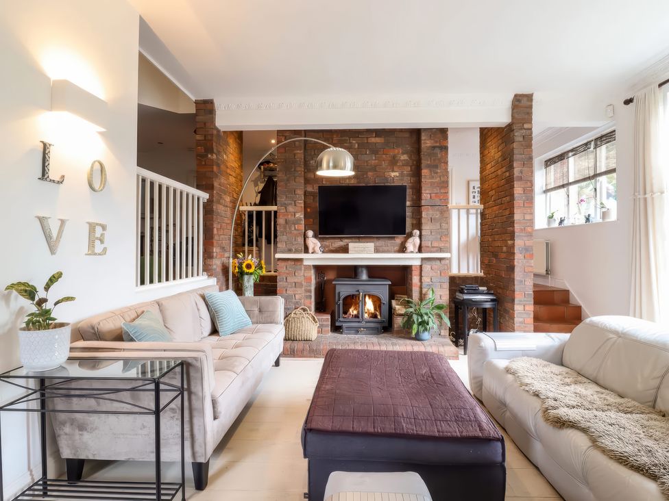 A living room with a fireplace and television at Forest Getaway in 