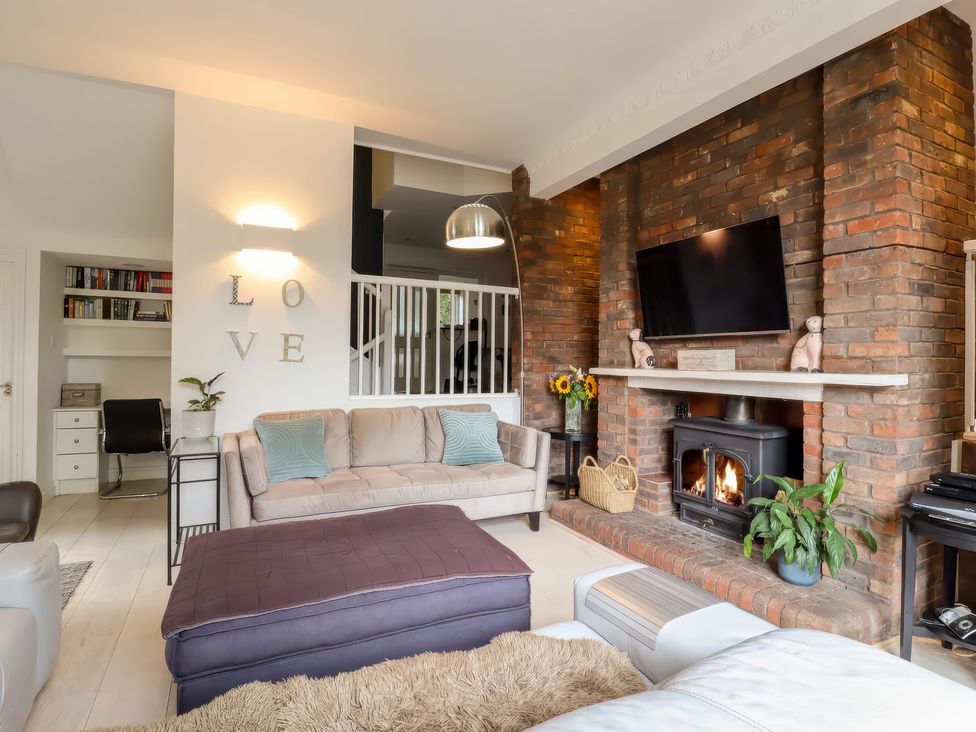 A living room with a sofa and fireplace at Forest Getaway