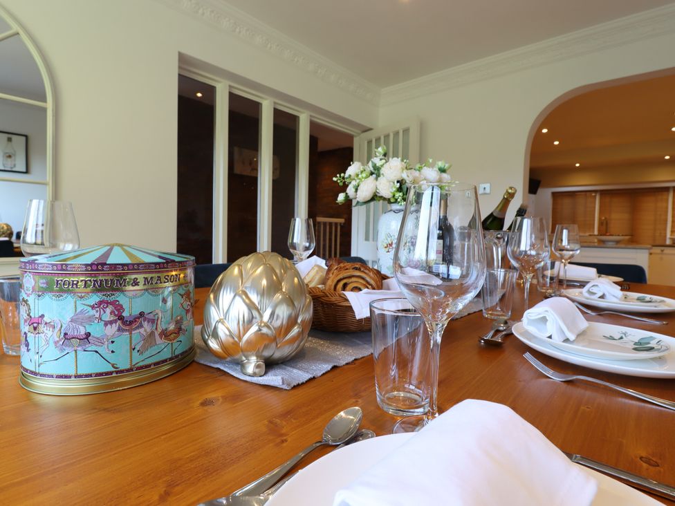 A dining room with a table set for a meal at Forest Getaway