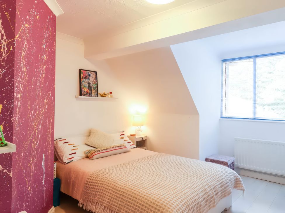 A bedroom with a bed and lamp at Forest Getaway