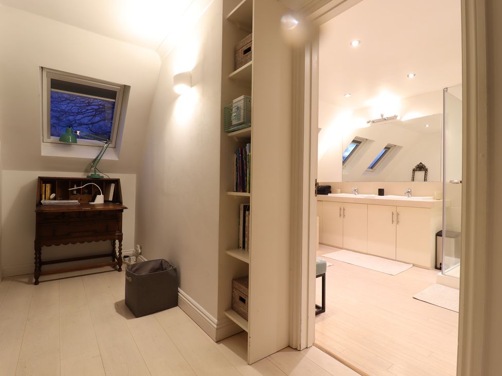 A bathroom with sink and shower visible from the entrance at Forest Getaway