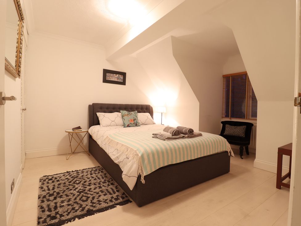 A bedroom with a bed and nightstand at Forest Getaway