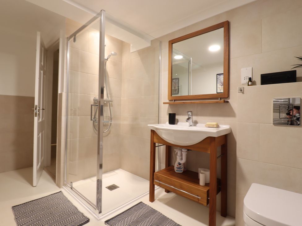A bathroom with a shower and sink at Forest Getaway