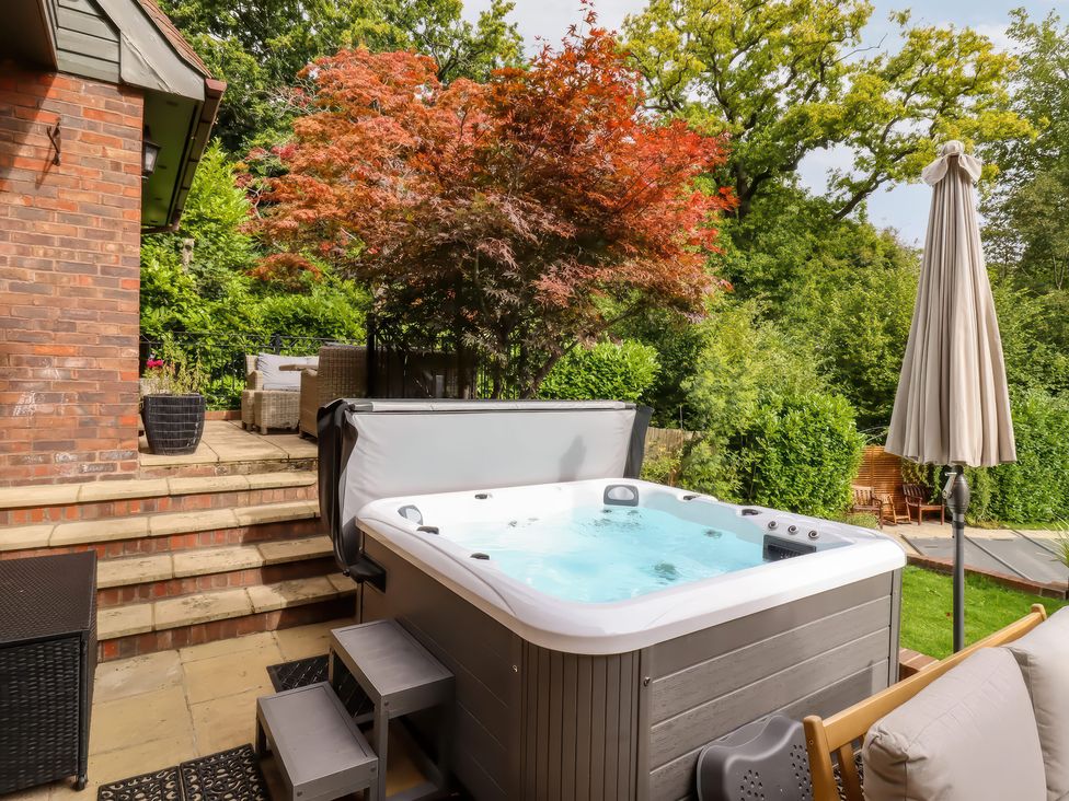 A garden with a hot tub, steps, and outdoor seating at Forest Getaway