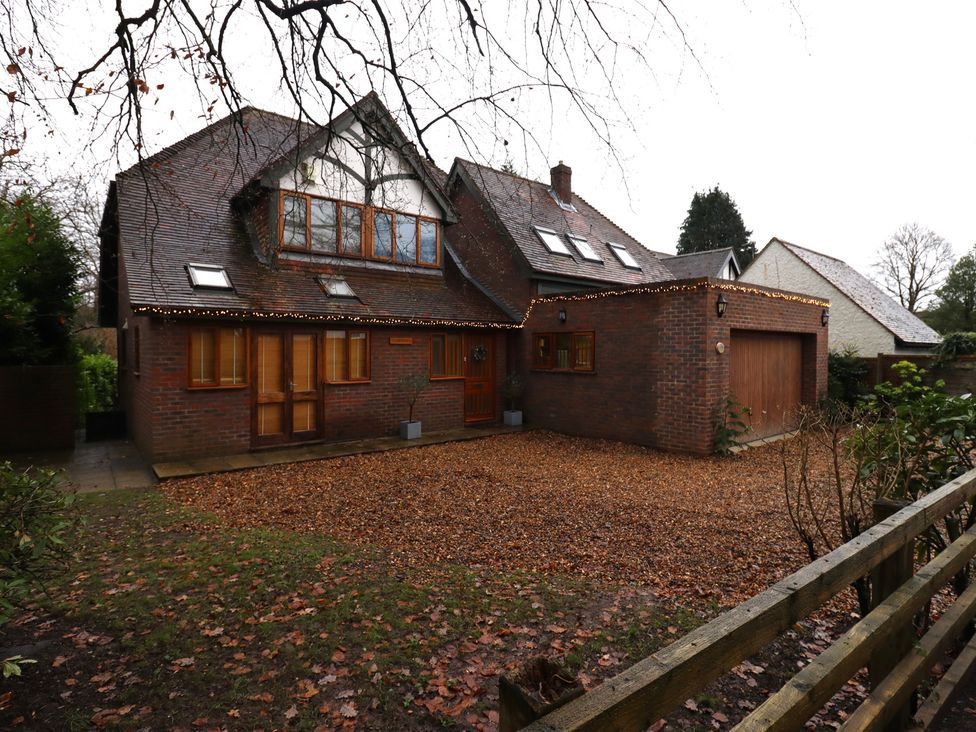 A house with a garage and decorative lights at Forest Getaway