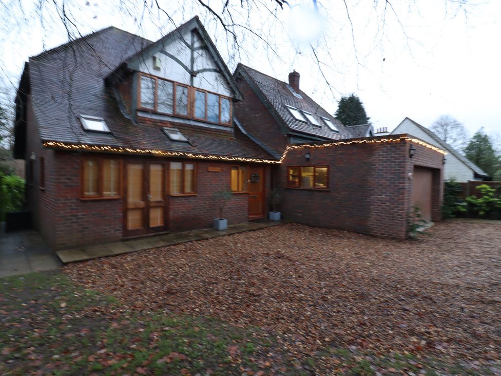 A house with a garage and pathway at Forest Getaway 