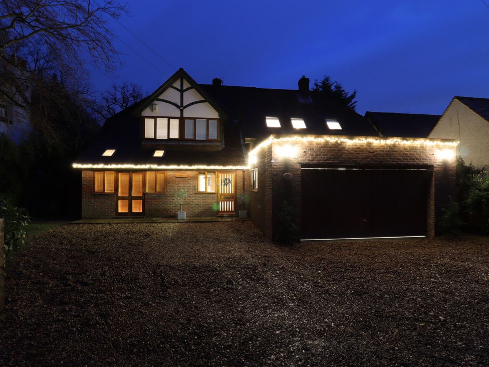 A house with a garage and outdoor lights at Forest Getaway in 