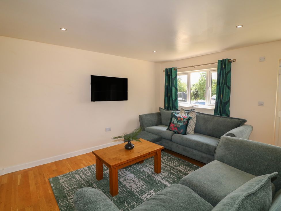 A living room with a television and window at James Ville Marina Lodge 22 in Brigg