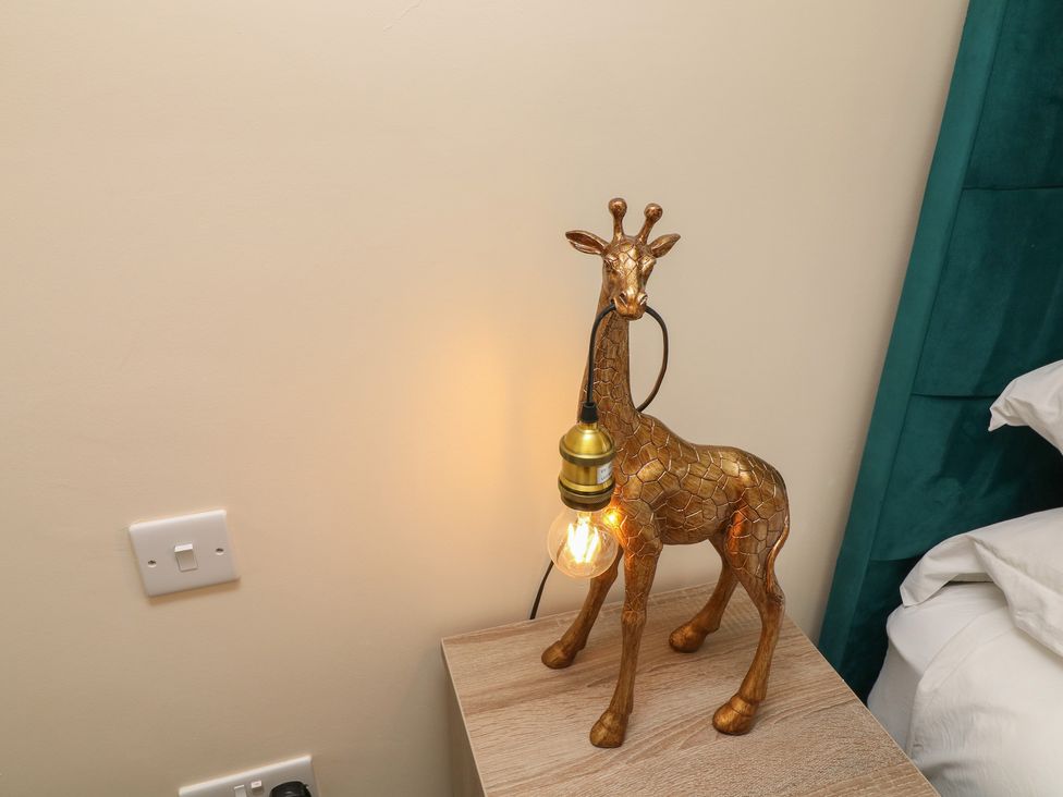 A giraffe lamp on a bedside table at James Ville Marina Lodge 22 in Brigg