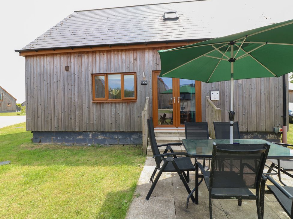 A wooden building with a table and chairs outside at James Ville Marina Lodge 22 in Brigg