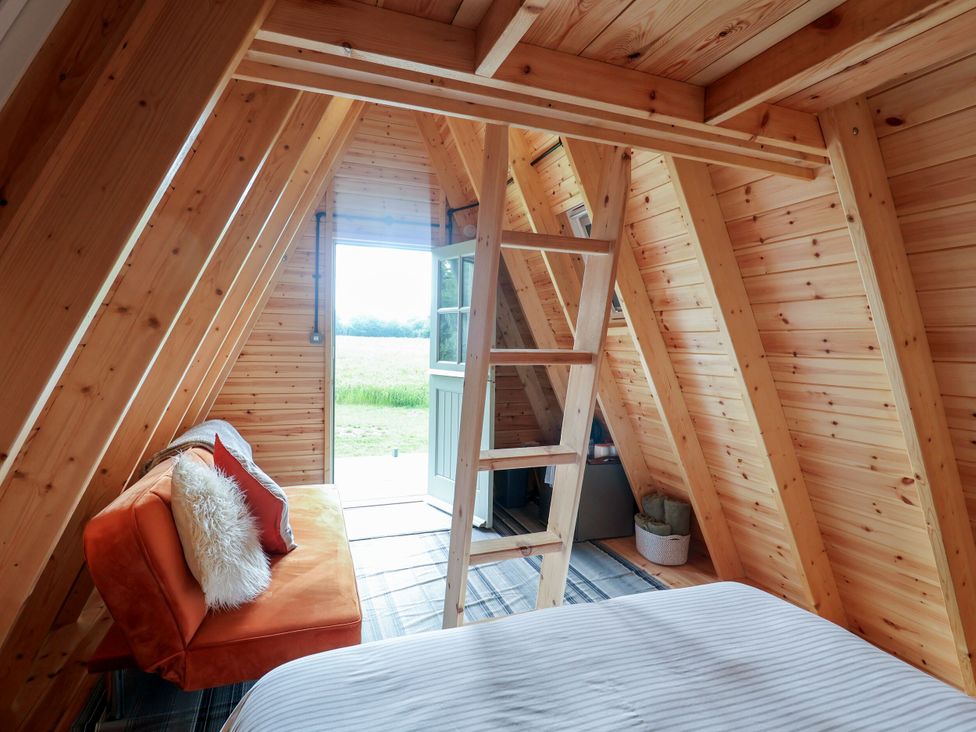 A cozy space with a ladder and sofa at Robin in Monewden near Otley, Suffolk