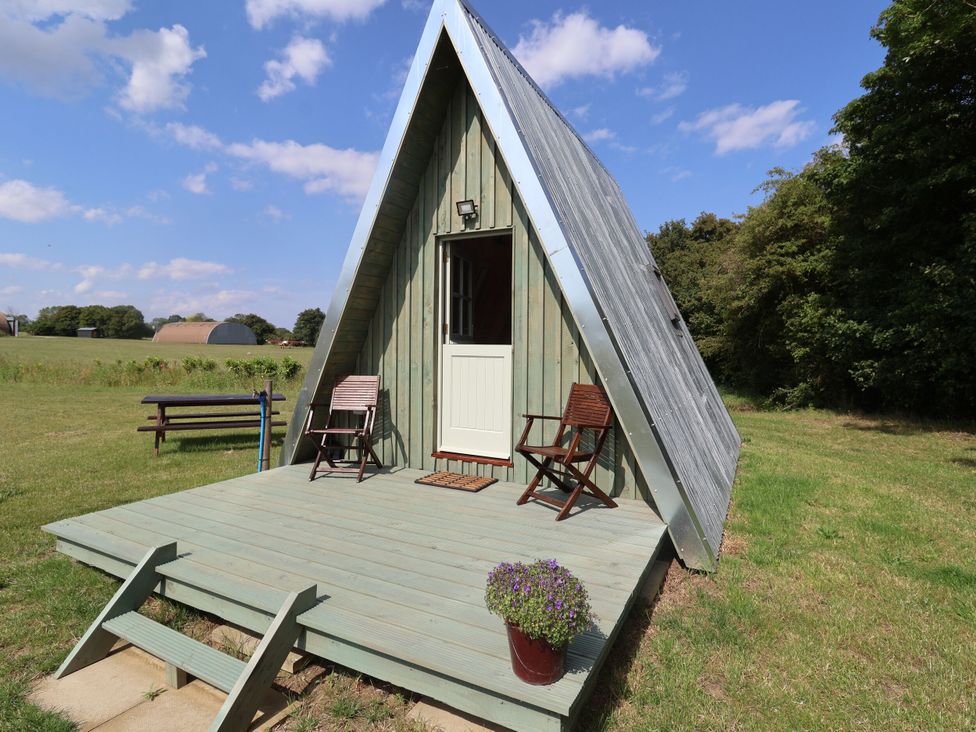 An A-frame structure with a deck and chairs at Robin in Monewden near Otley, Suffolk