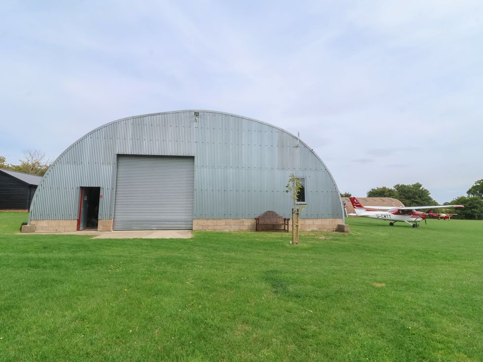A hangar with aircraft outside at Robin in Monewden near Otley, Suffolk