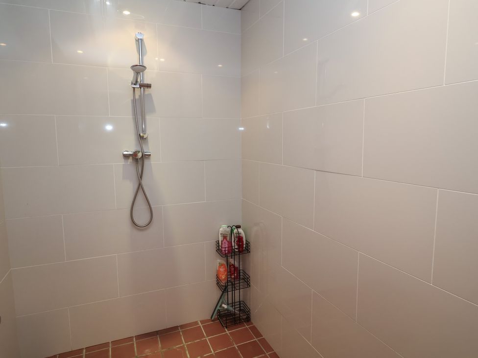 A shower area with tiles and a soap rack at Robin in Monewden near Otley Suffolk