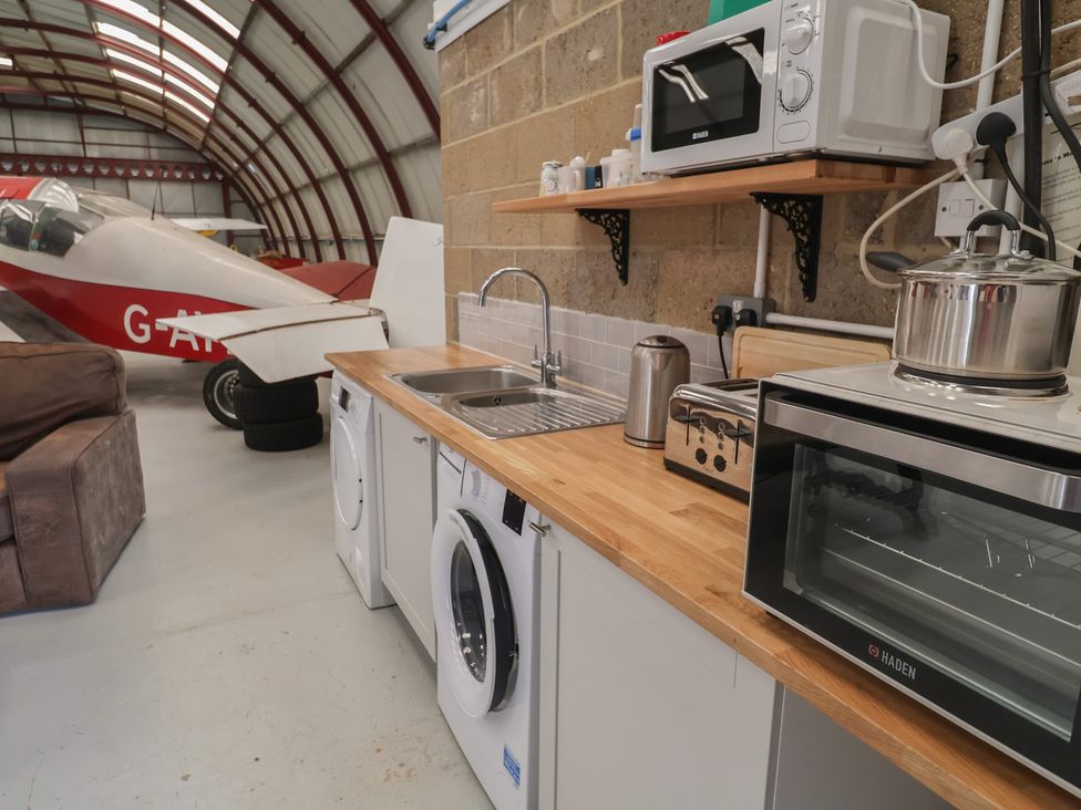 A kitchen with appliances and an airplane in the background at Robin in Monewden near Otley, Suffolk