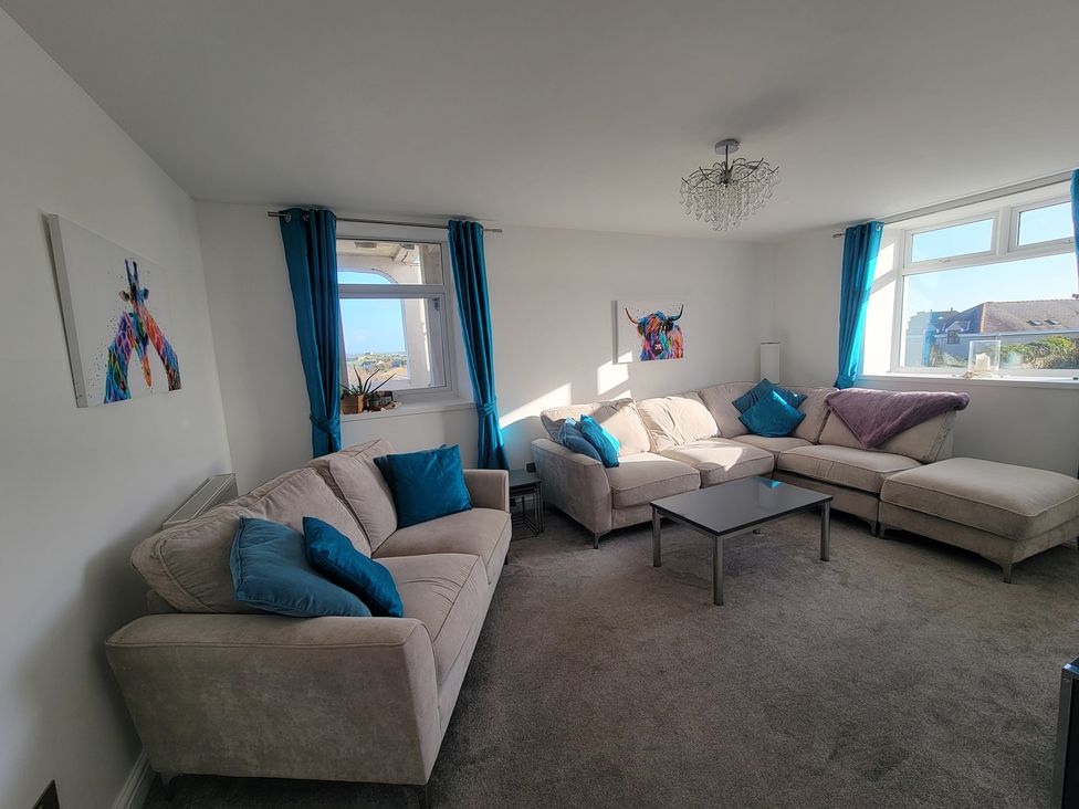 A living room with sofas and a coffee table at Plas Darien no 28 Trearddur Bay