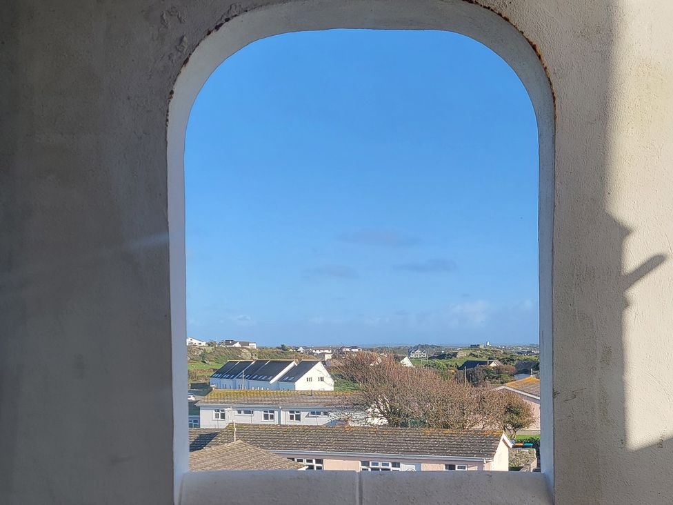 A view from a window showing houses and a clear sky at Plas Darien no 28 Trearddur Bay