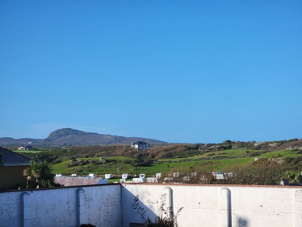 A view of fields and a mountain at Plas Darien no 28 Trearddur Bay