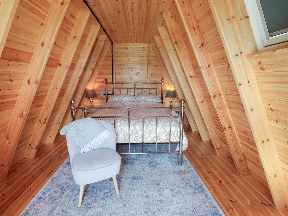 A bedroom with a bed and chair at 1 Bed Sleeps 2, Shared Bathroom in Monewden near Otley, Suffolk