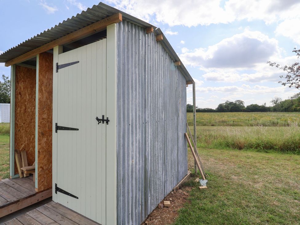 A shed with a wooden door in an outdoor area