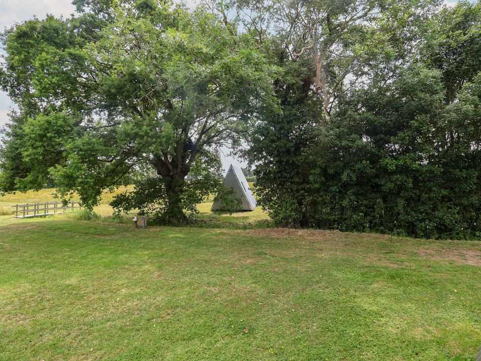 A tent surrounded by trees and grass at 1 Bed Sleeps 2, Shared Bathroom in Monewden near Otley, Suffolk