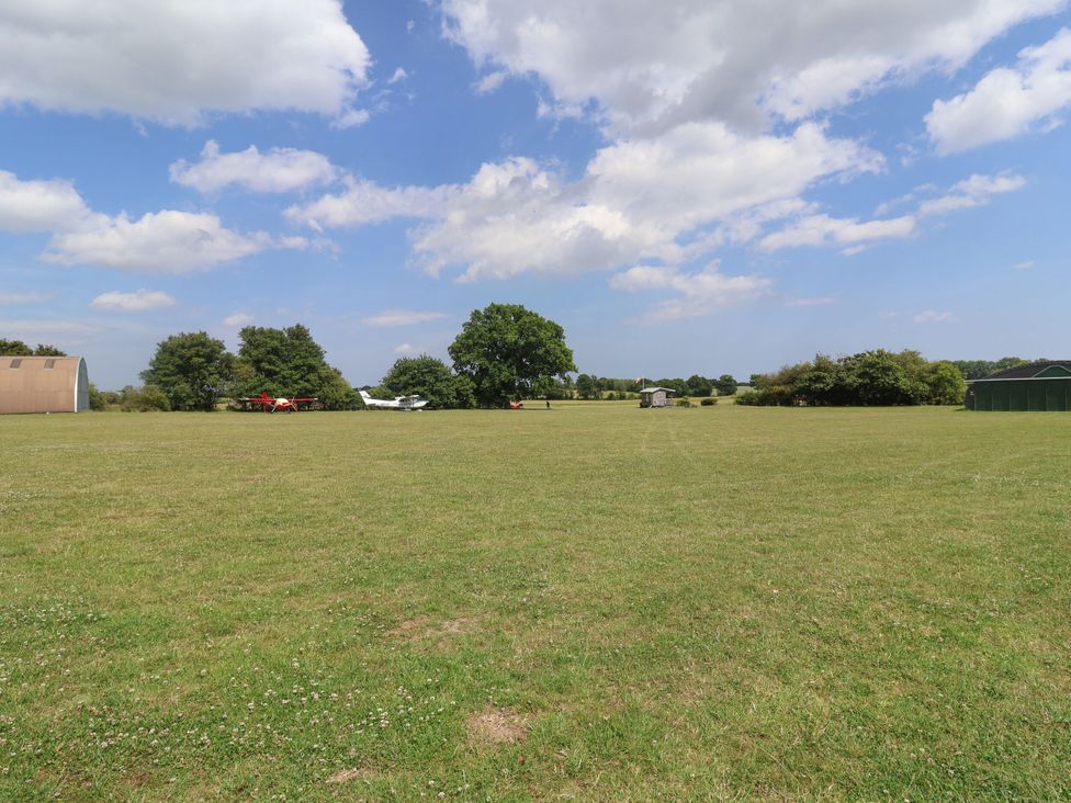 An outdoor area with airplanes and a hangar at 1 Bed Sleeps 2, Shared Bathroom, Monewden near Otley, Suffolk