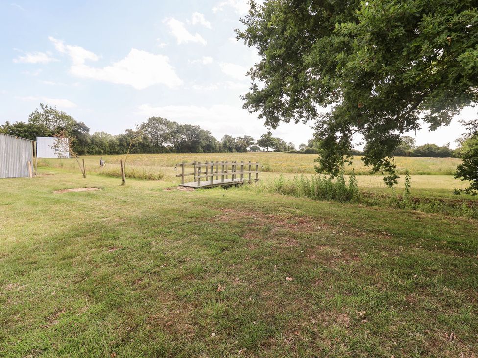 An outdoor space with a wooden deck and trees at 1 Bed Sleeps 2, Shared Bathroom, Monewden near Otley, Suffolk