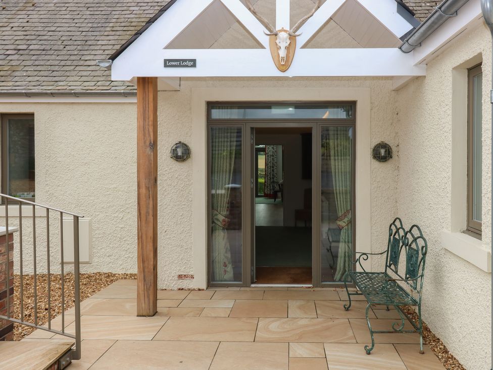 An entrance with a bench and door at Lower Lodge in Cupar