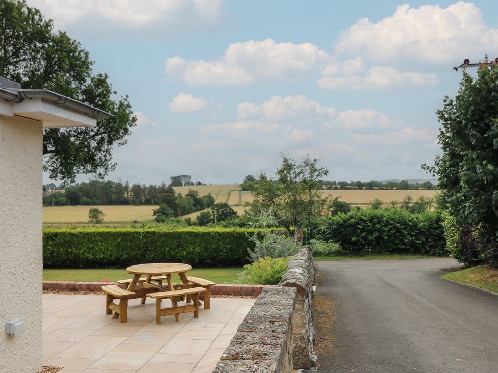 A patio area with a table and chairs at Lower Lodge Cupar