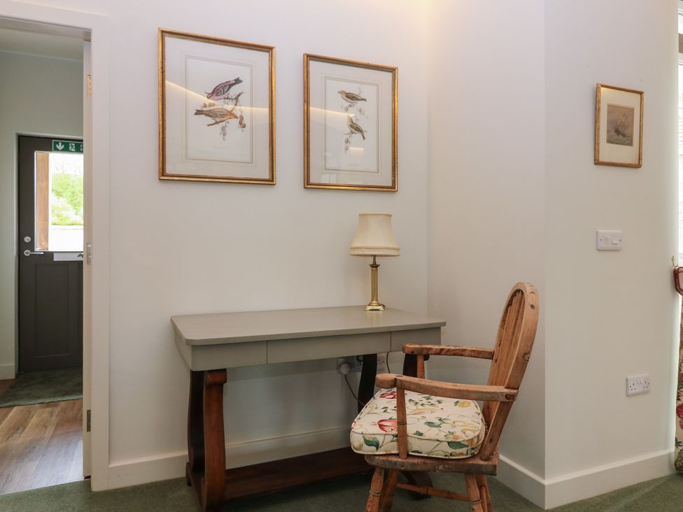 A desk with a chair and artwork in an entryway at Lower Lodge Cupar
