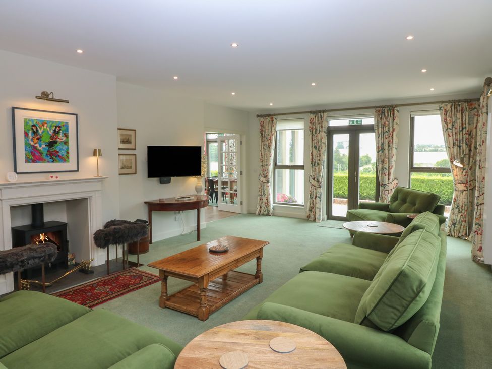 A living room with a green sofa and coffee table at Lower Lodge in Cupar