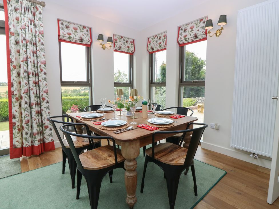 A dining room with a table set for meals at Lower Lodge in Cupar