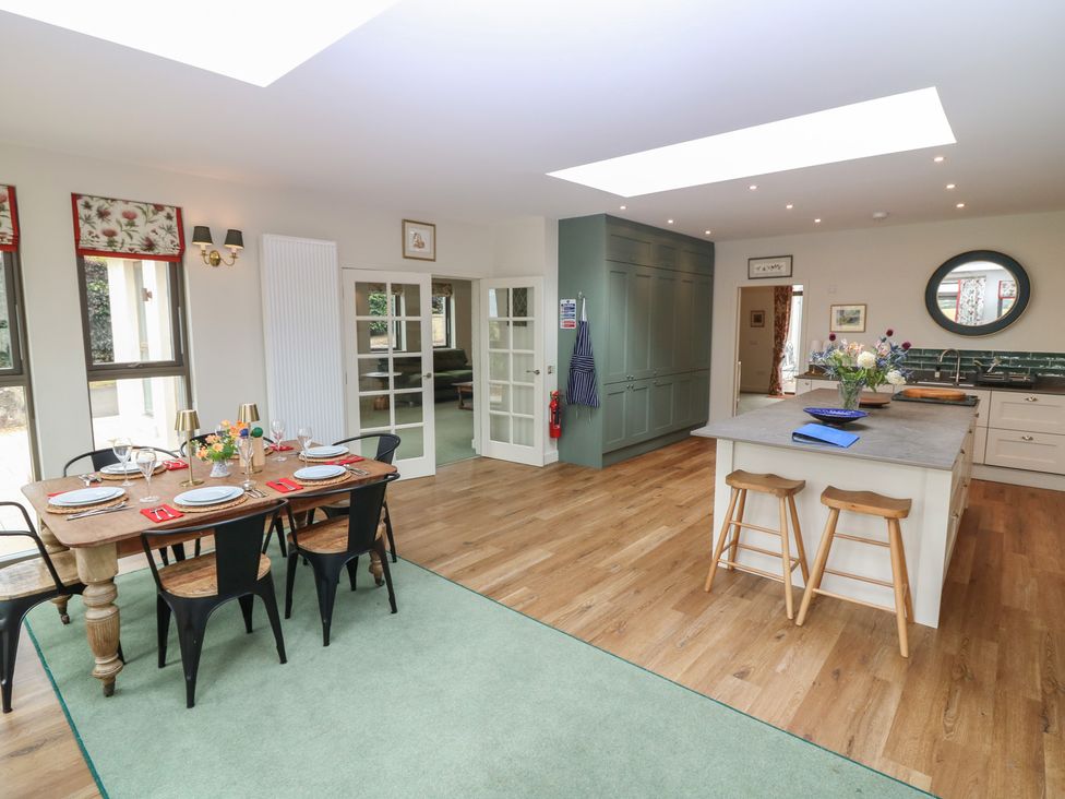 A kitchen with a table and chairs at Lower Lodge in Cupar