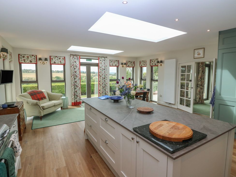A kitchen with an island and sofa at Lower Lodge in Cupar