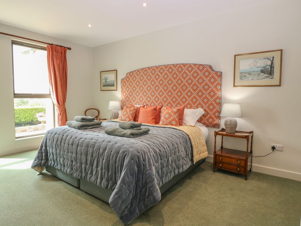A bedroom with a bed and bedside table at Lower Lodge in Cupar