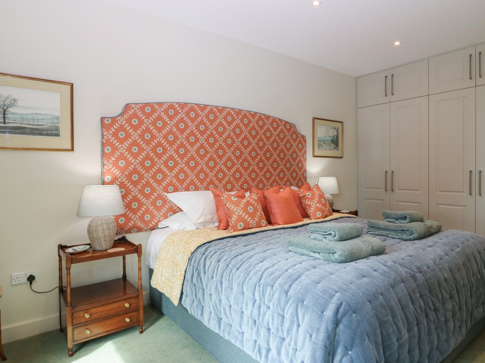 A bedroom with a bed and bedside table at Lower Lodge in Cupar