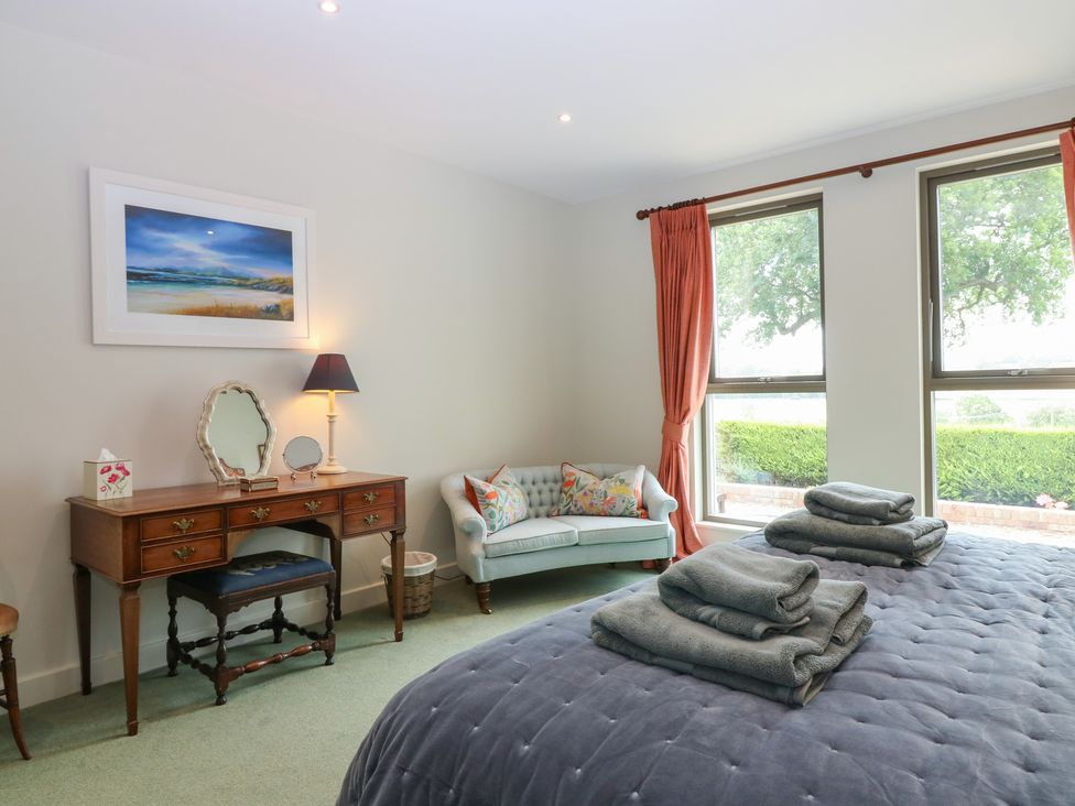 A bedroom with a bed and desk at Lower Lodge in Cupar