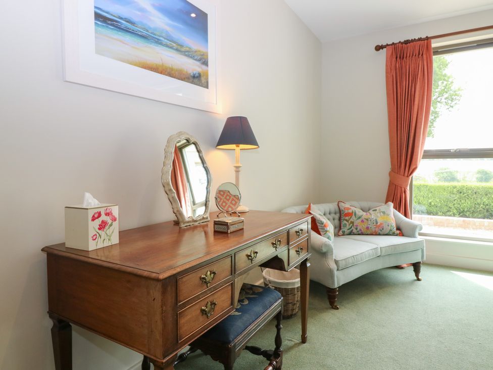 A living room with a desk and sofa at Lower Lodge in Cupar