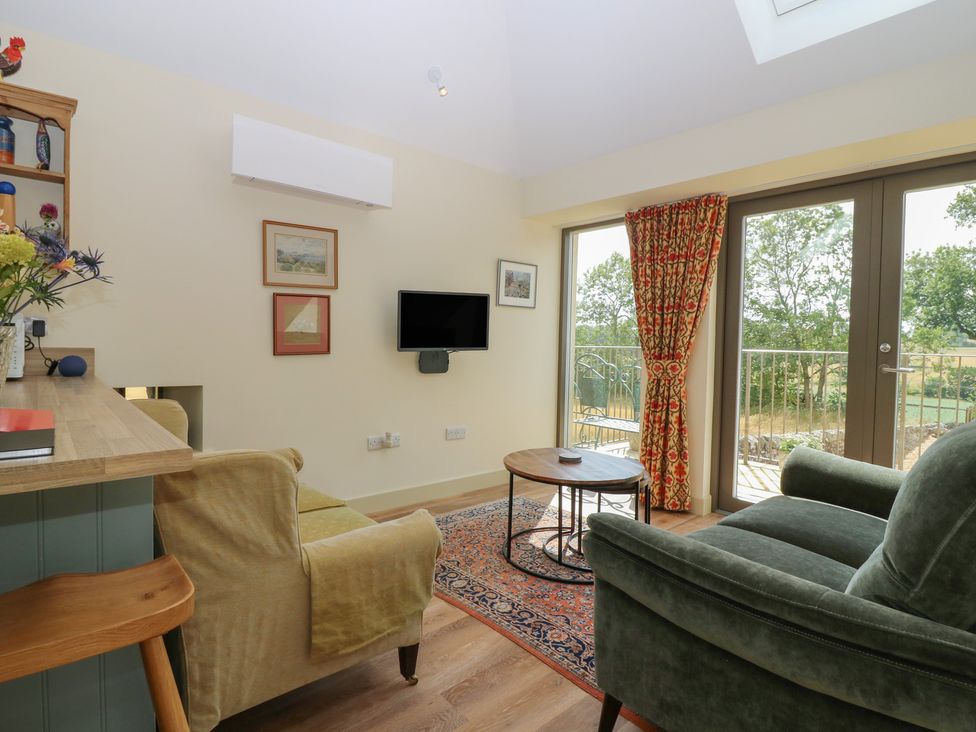 A living room with a sofa and television at The Barn, Lower Lodge Cupar