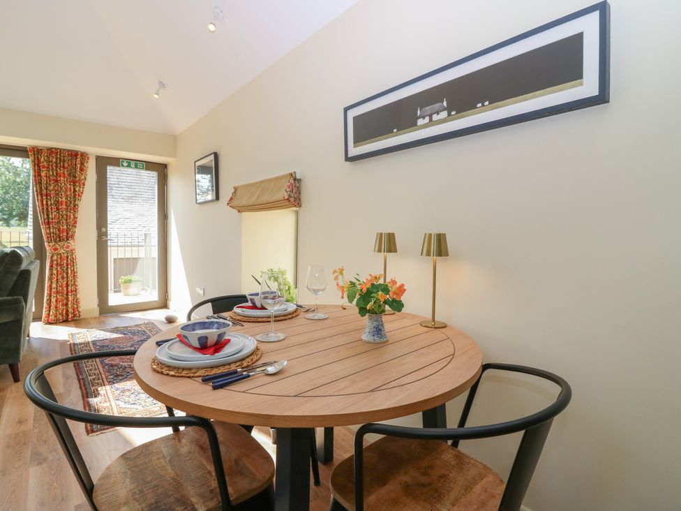 A dining area with a table set for two at The Barn, Lower Lodge in Cupar