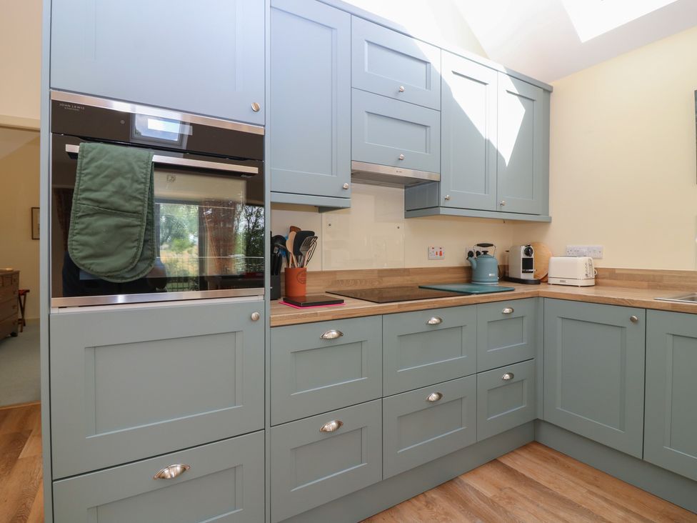 A kitchen with cabinets and appliances at The Barn, Lower Lodge in Cupar