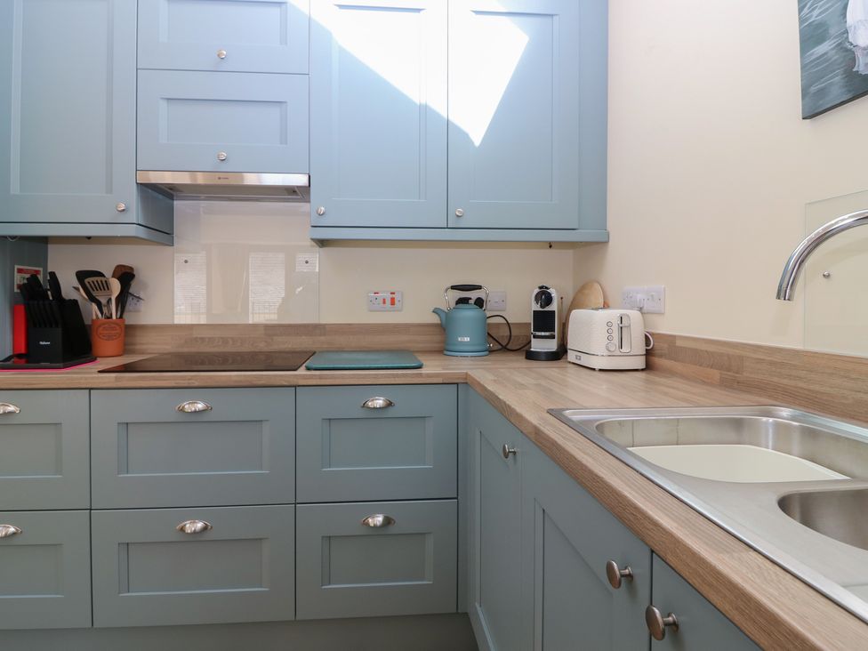A kitchen with cabinets and appliances at The Barn, Lower Lodge in Cupar