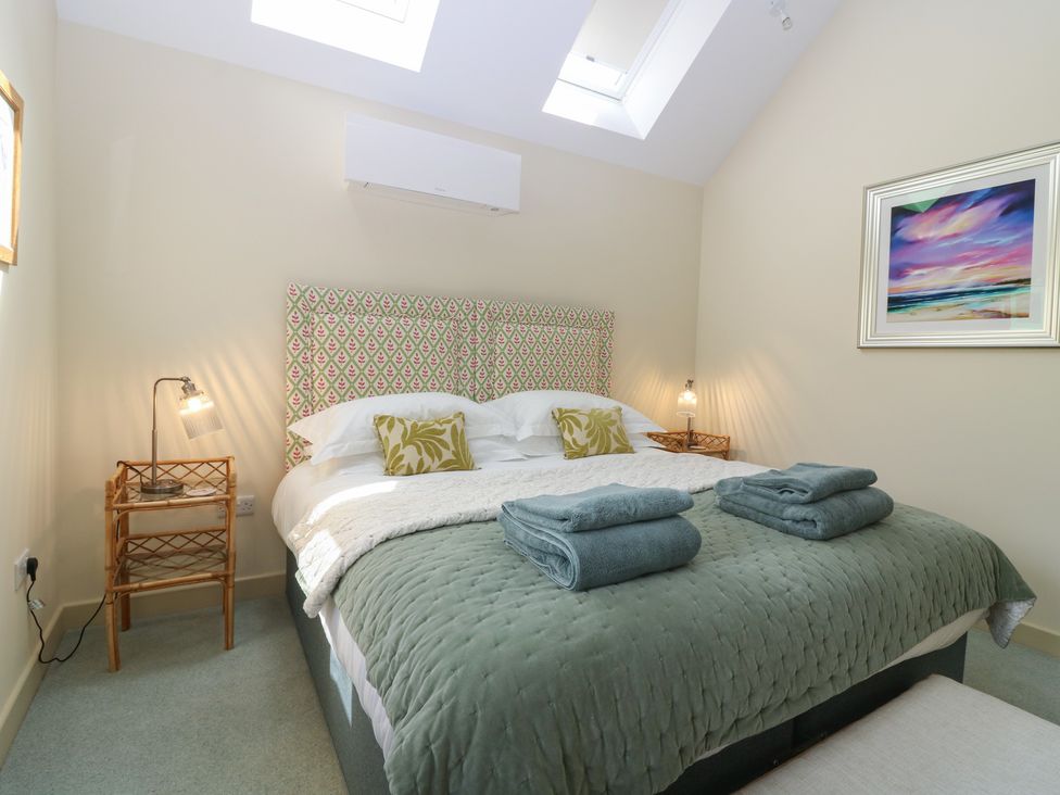 A bedroom with a double bed and bedside table at The Barn, Lower Lodge in Cupar