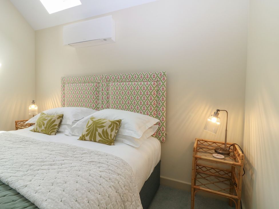 A bedroom with a bed and nightstand at The Barn, Lower Lodge in Cupar