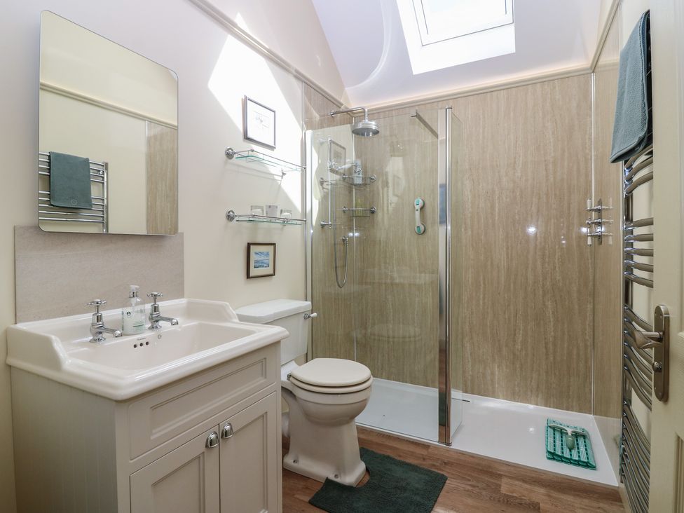 A bathroom with a shower, sink, and toilet at The Barn, Lower Lodge in Cupar
