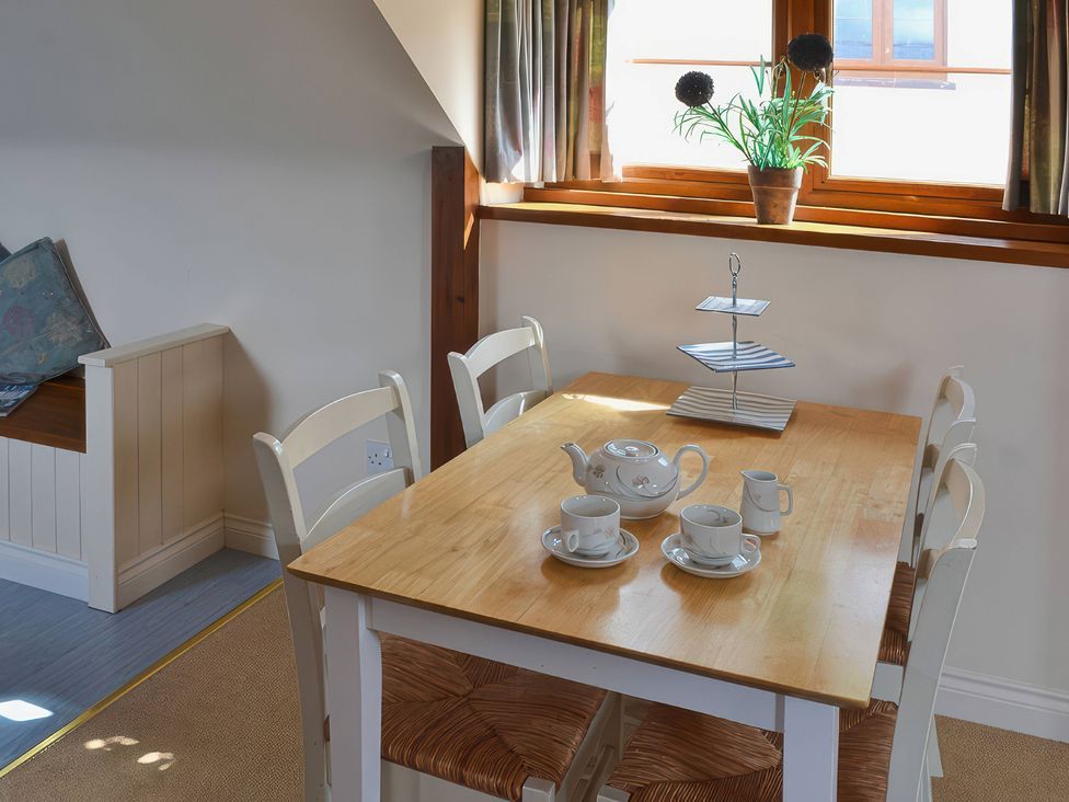 A dining room with a table set for tea at The Stables Budock Water near Falmouth
