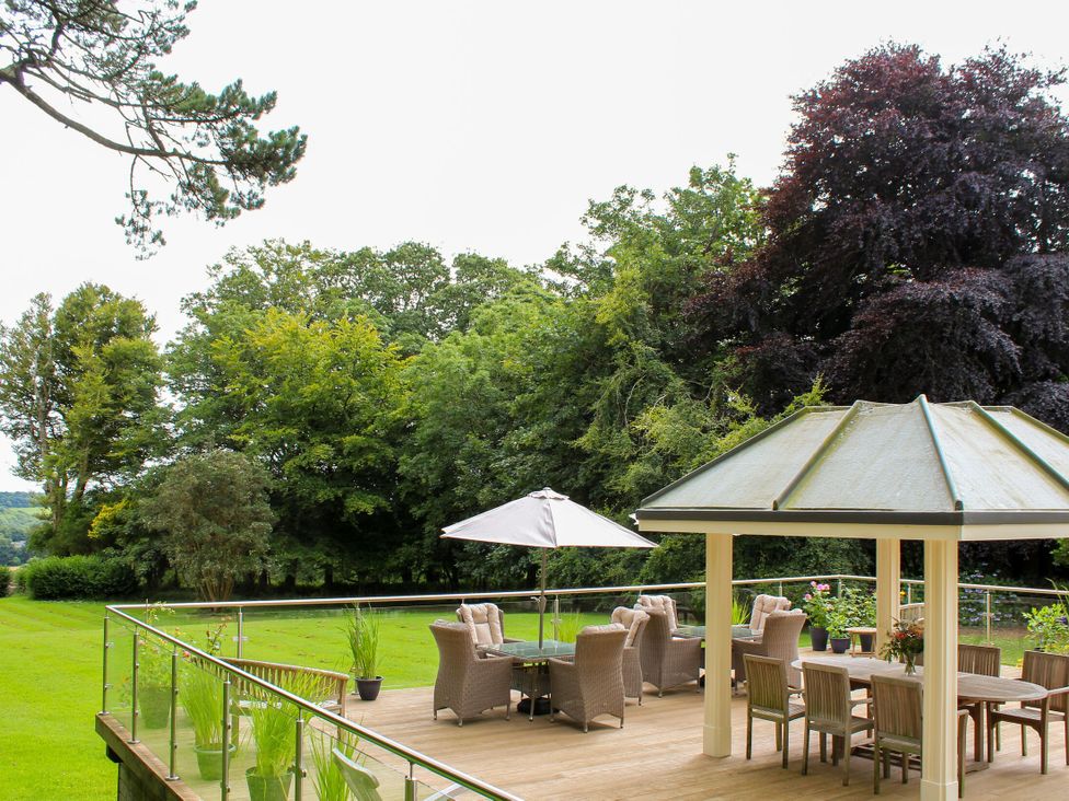 An outdoor seating area with a table and chairs at The Stables in Budock Water near Falmouth