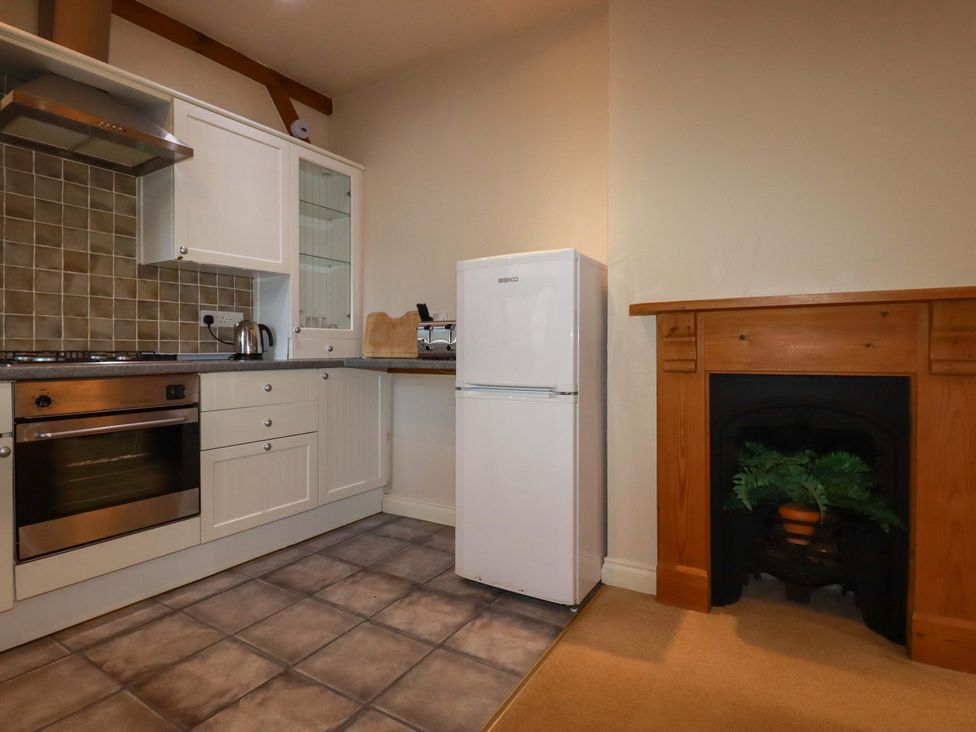 A kitchen with a refrigerator and an oven at Farrier Cottage, Falmouth